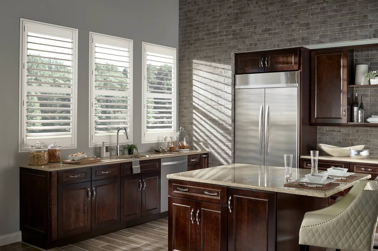 open plantation shutters on 3 large kitchen windows