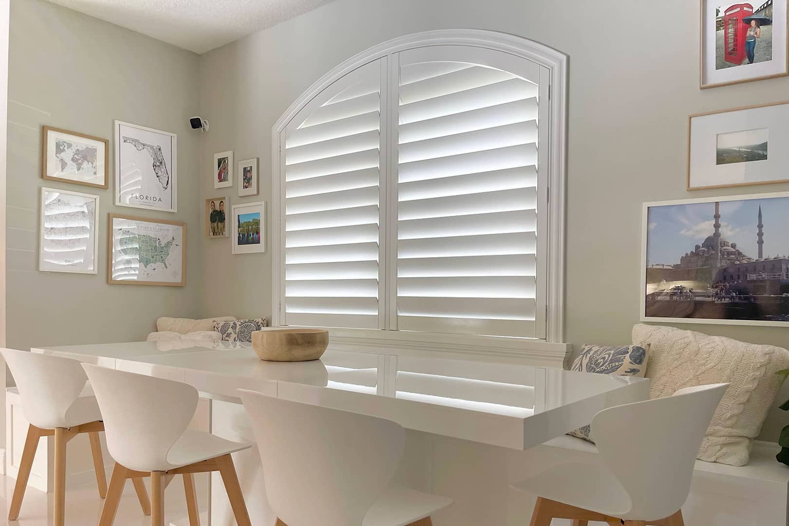 plantation shutters on an arch-topped window