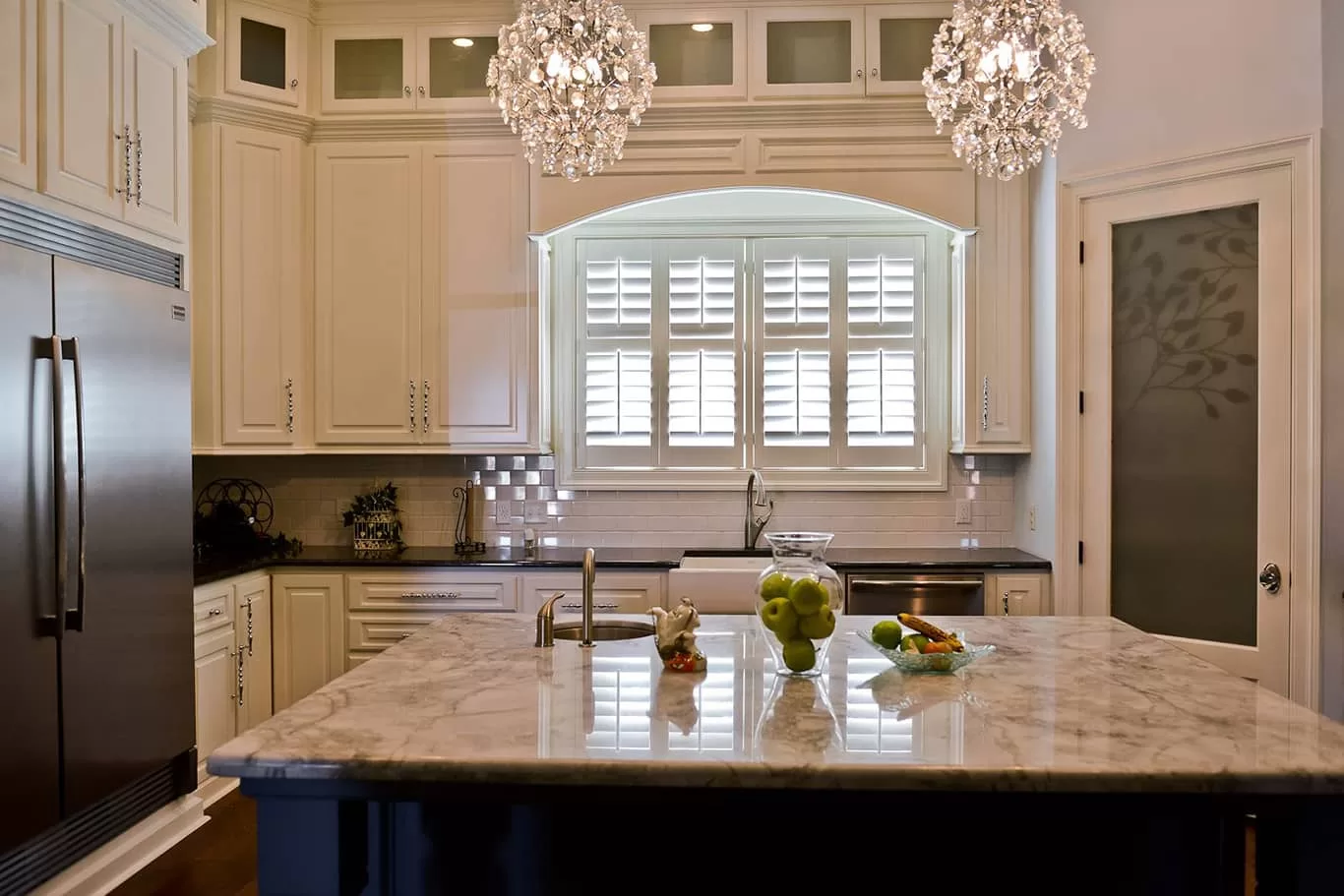 plantation shutters on arched kitchen window