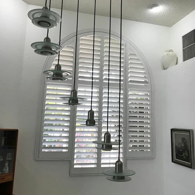 plantation shutters on arched window