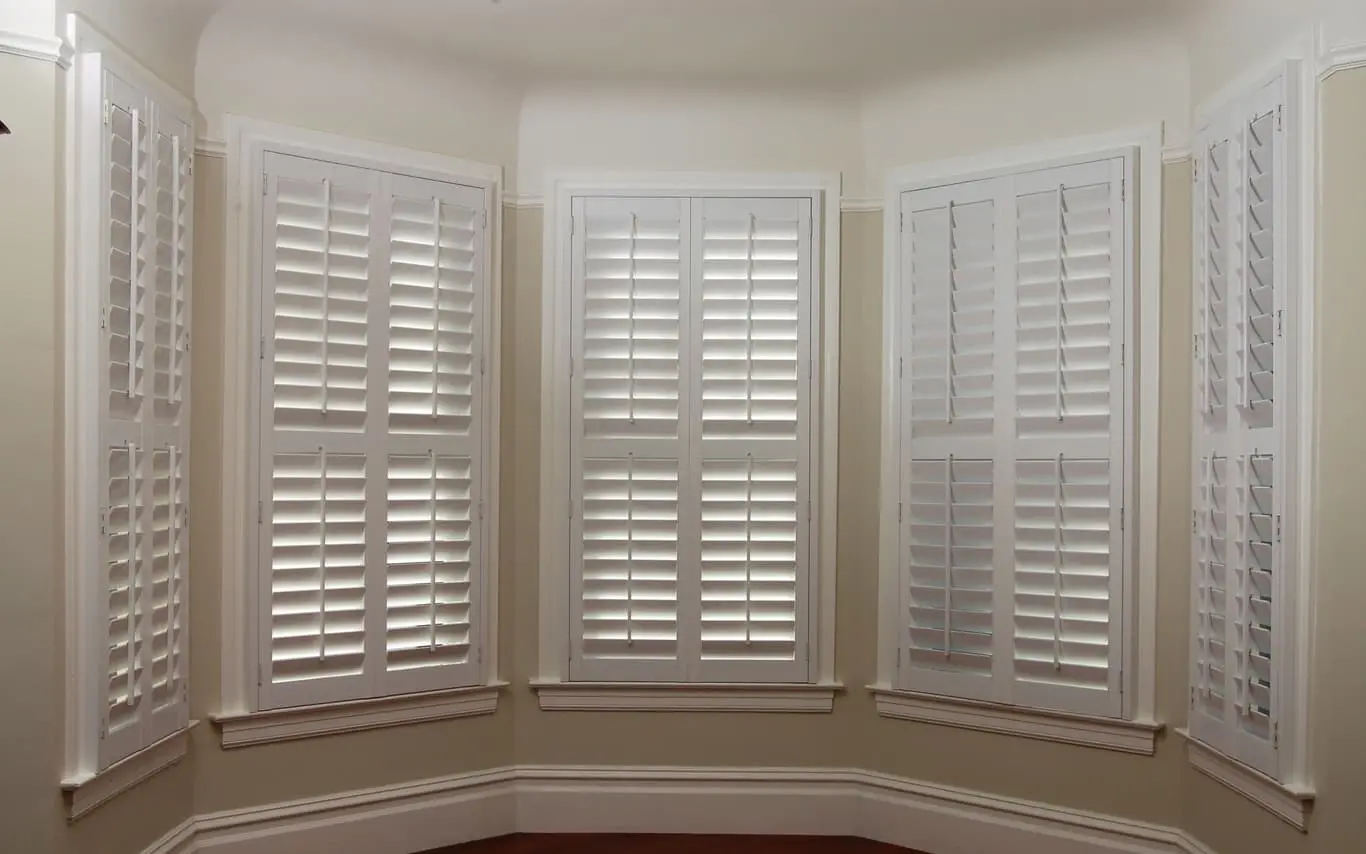 plantation shutters on multiple windows in a bay