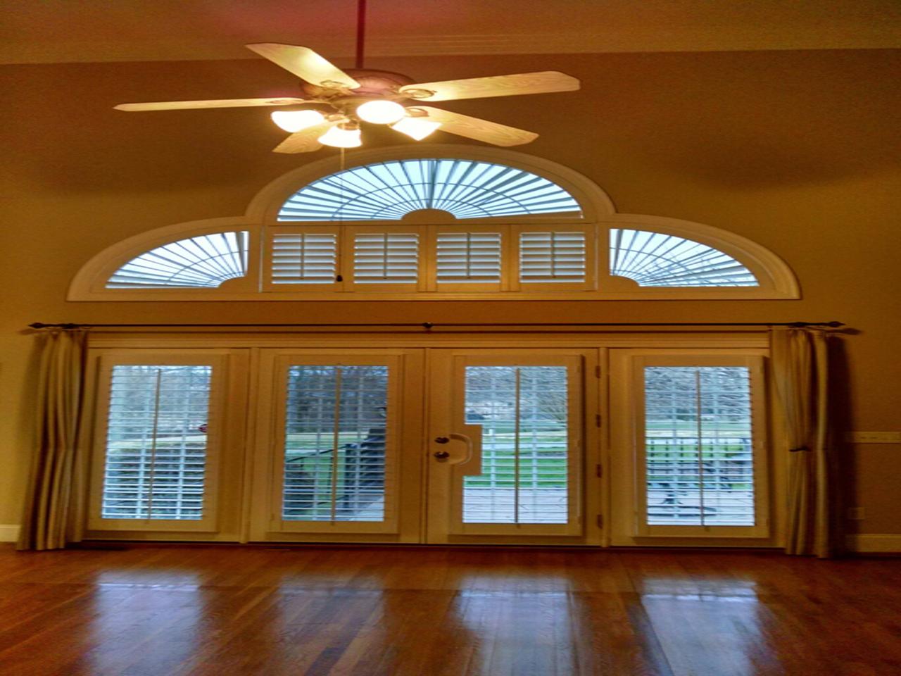 Arched windows and french doors with shutters