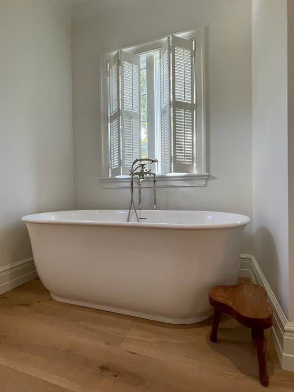 traditional shutters above a bathtub