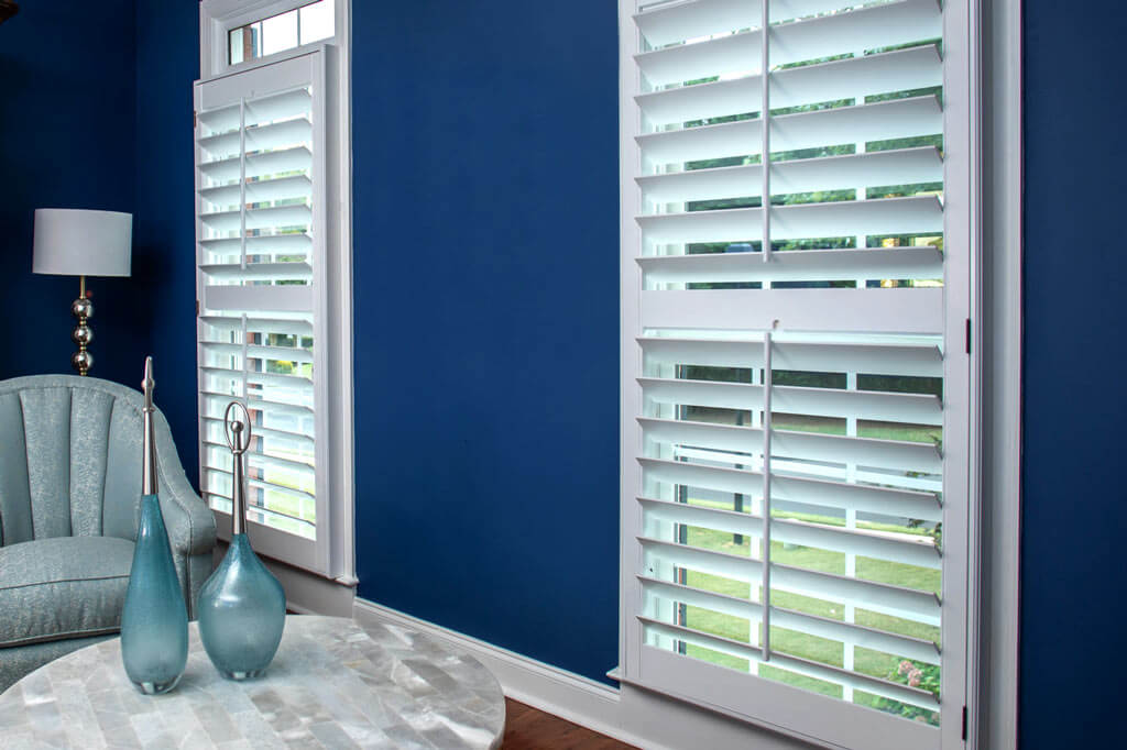 white Heritage shutters on blue living room walls